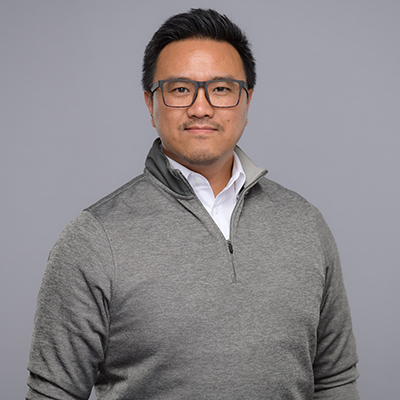Portrait of man in gray against gray backdrop